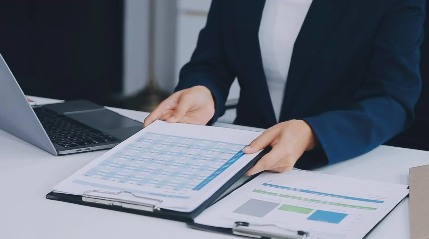 Freelancer checking tax schedule and expense report on a tablet in a home office setting