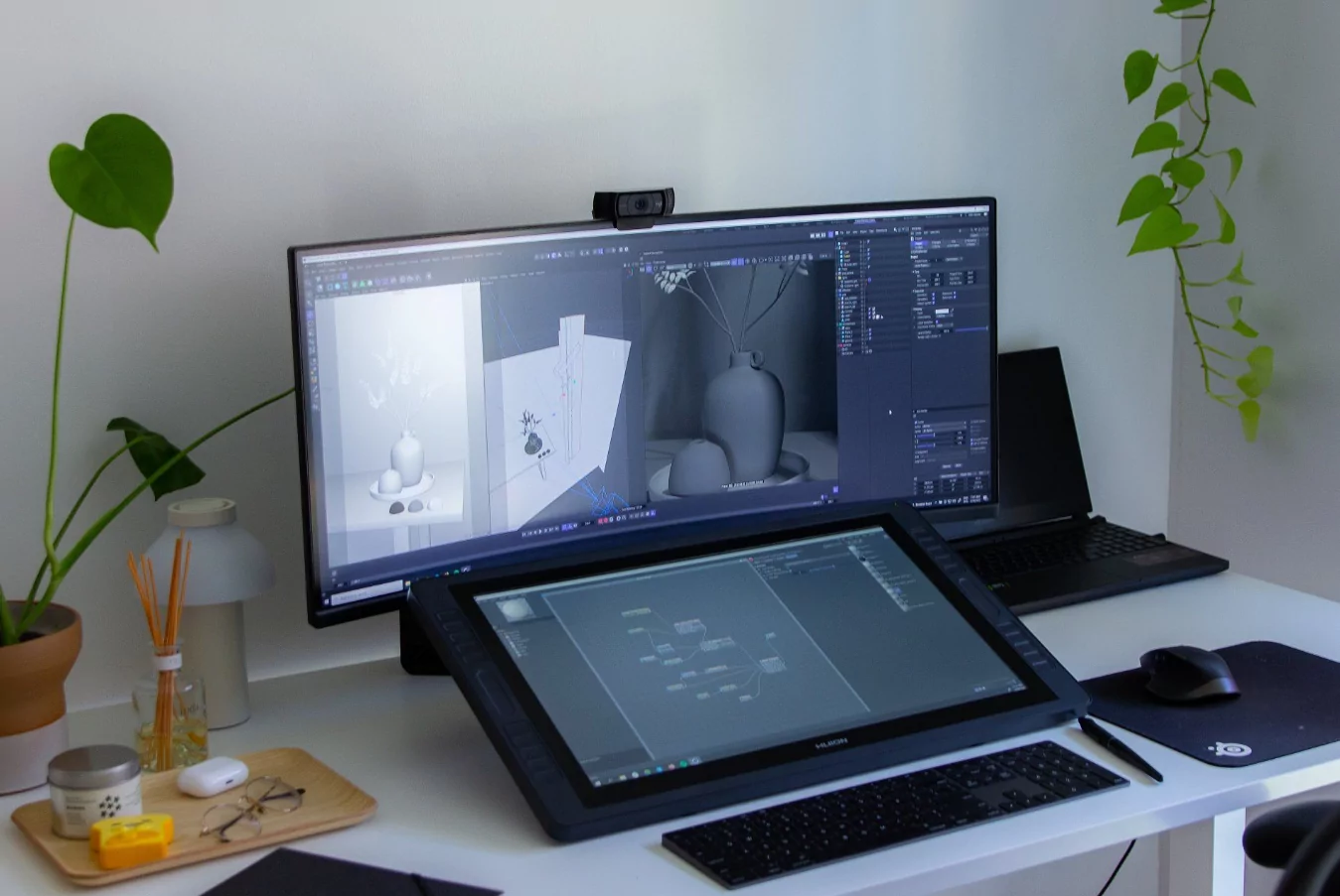 Modern office desk with a tablet displaying a digital planner next to a small plant